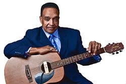 Johnny Rawls portrait with acoustic guitar